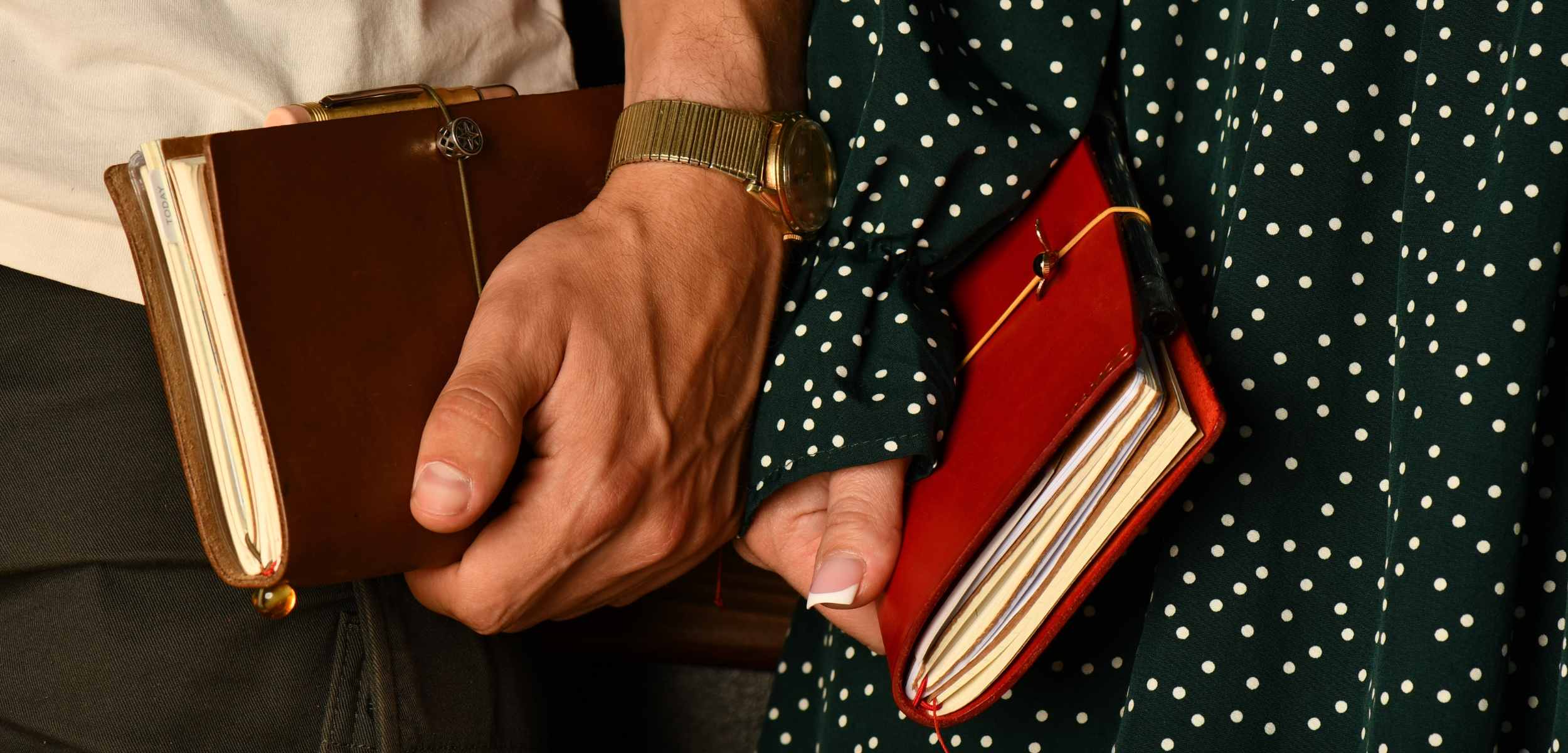 Couple-holding-pair-of-Bielinis-journals-desktop.jpg