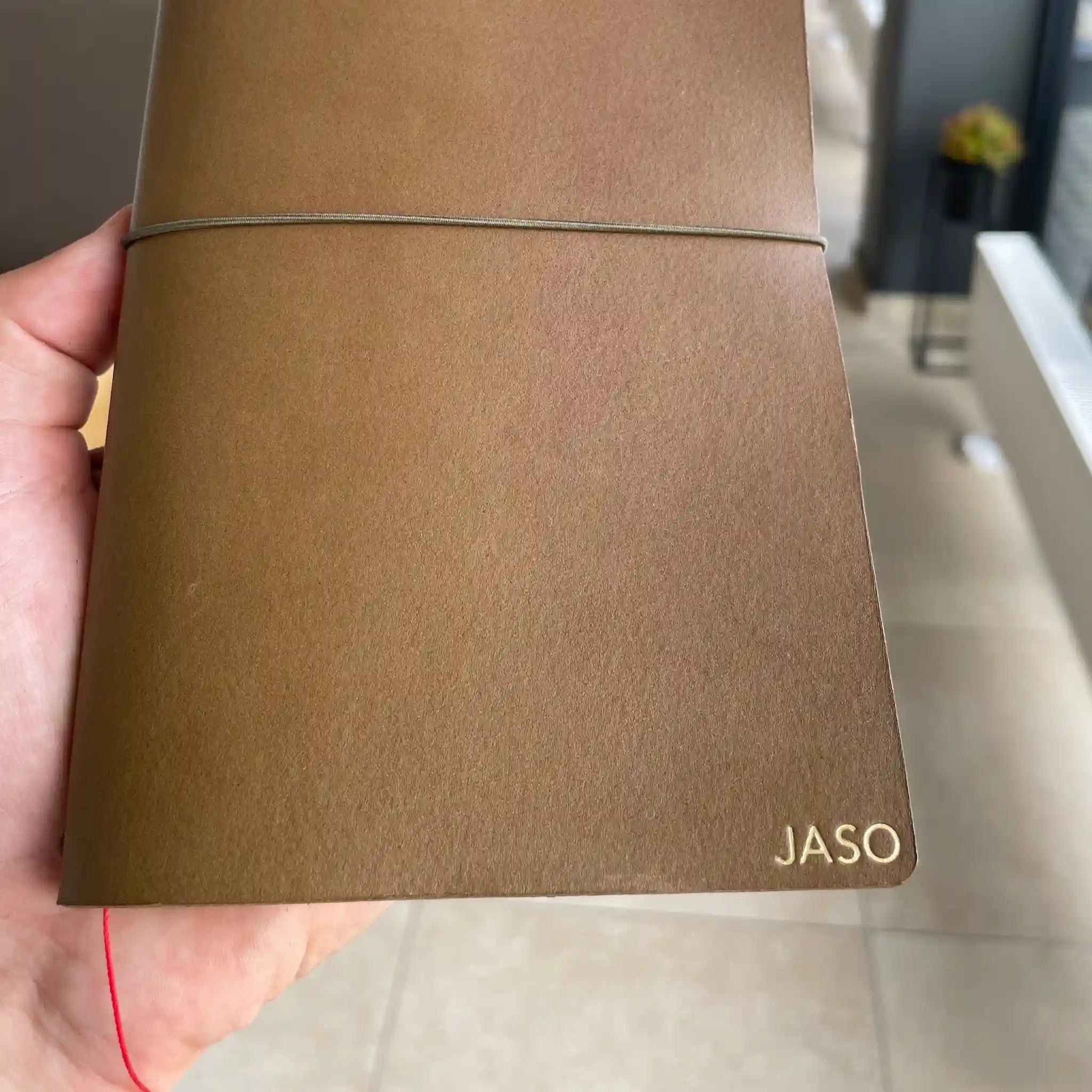 Close-up of gold embossed detail on a Bielinis handmade leather travelers’ journal, showcasing premium craftsmanship and elegant design.