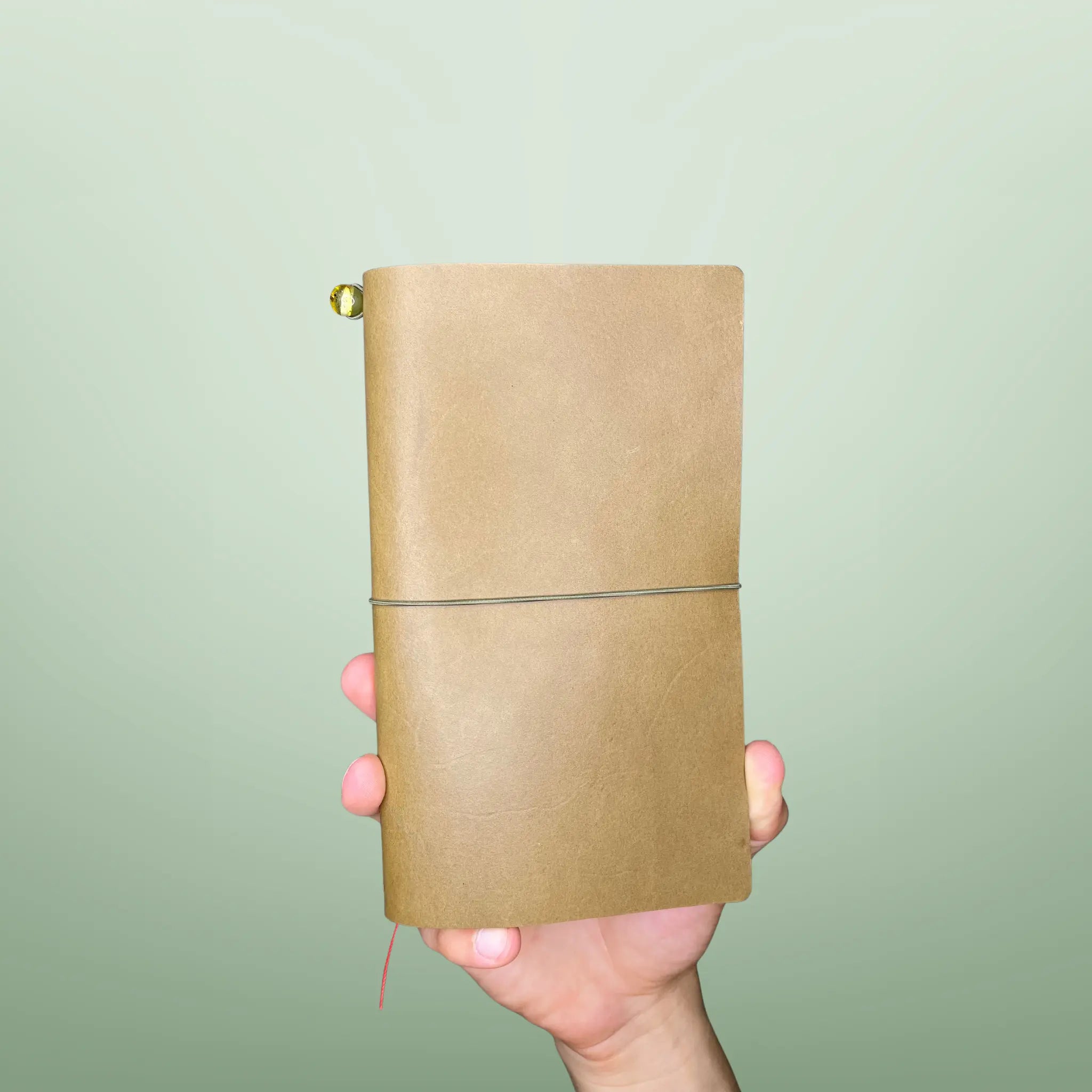 Bielinis handmade traveler’s leather journal Atlas in army green, front view highlighting genuine Baltic amber, premium craftsmanship and durable design.