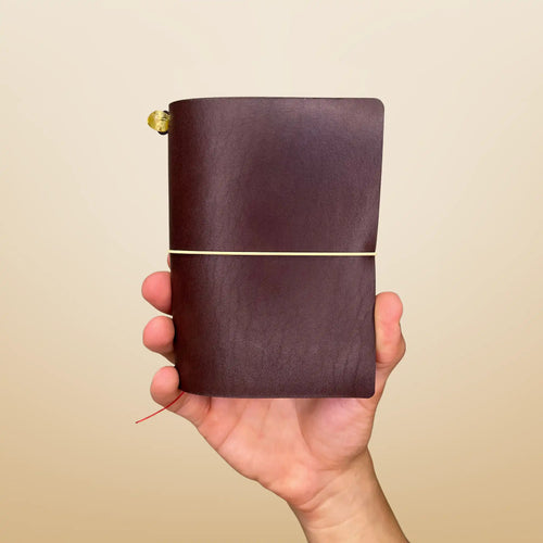 Bielinis best handmade traveler’s journal Vellum in rich dark brown leather, front view highlighting genuine Baltic amber accents and a pocket-friendly size designed for capturing your stories anywhere.