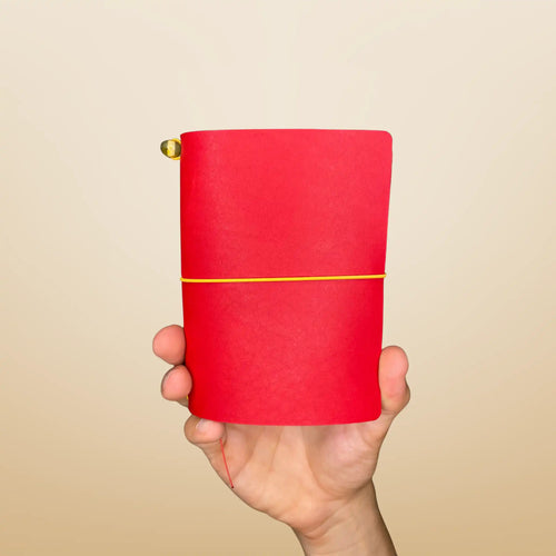 Bielinis best handmade traveler’s journal Vellum in vibrant red leather, front view showcasing genuine Baltic amber details and a compact, pocket-sized design crafted for on-the-go inspiration.