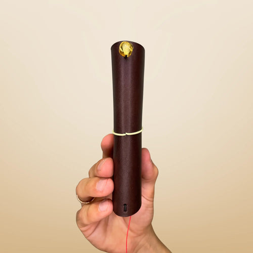 Bielinis handmade traveler’s journal Vellum in dark brown leather, side view featuring genuine Baltic amber accents and a palm-sized, portable design crafted for your everyday adventures.