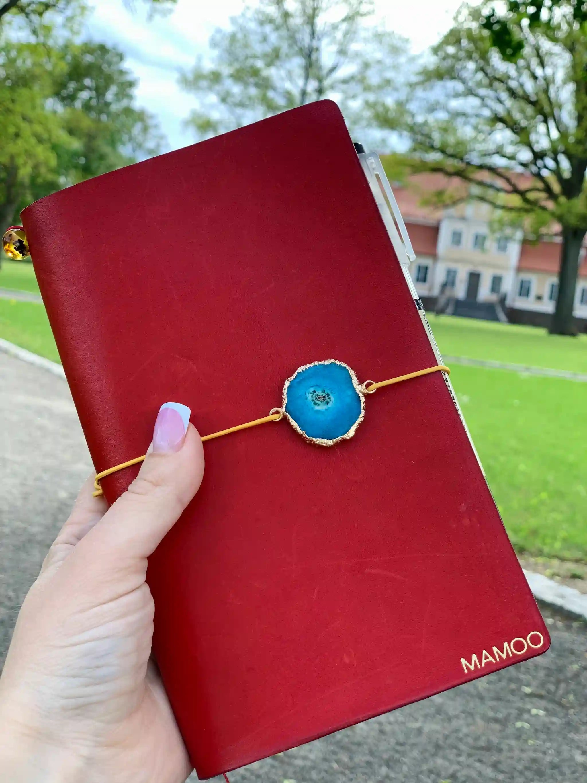 bielinis-red-leather-journal-blue-amazonite-slider-in-hand.webp