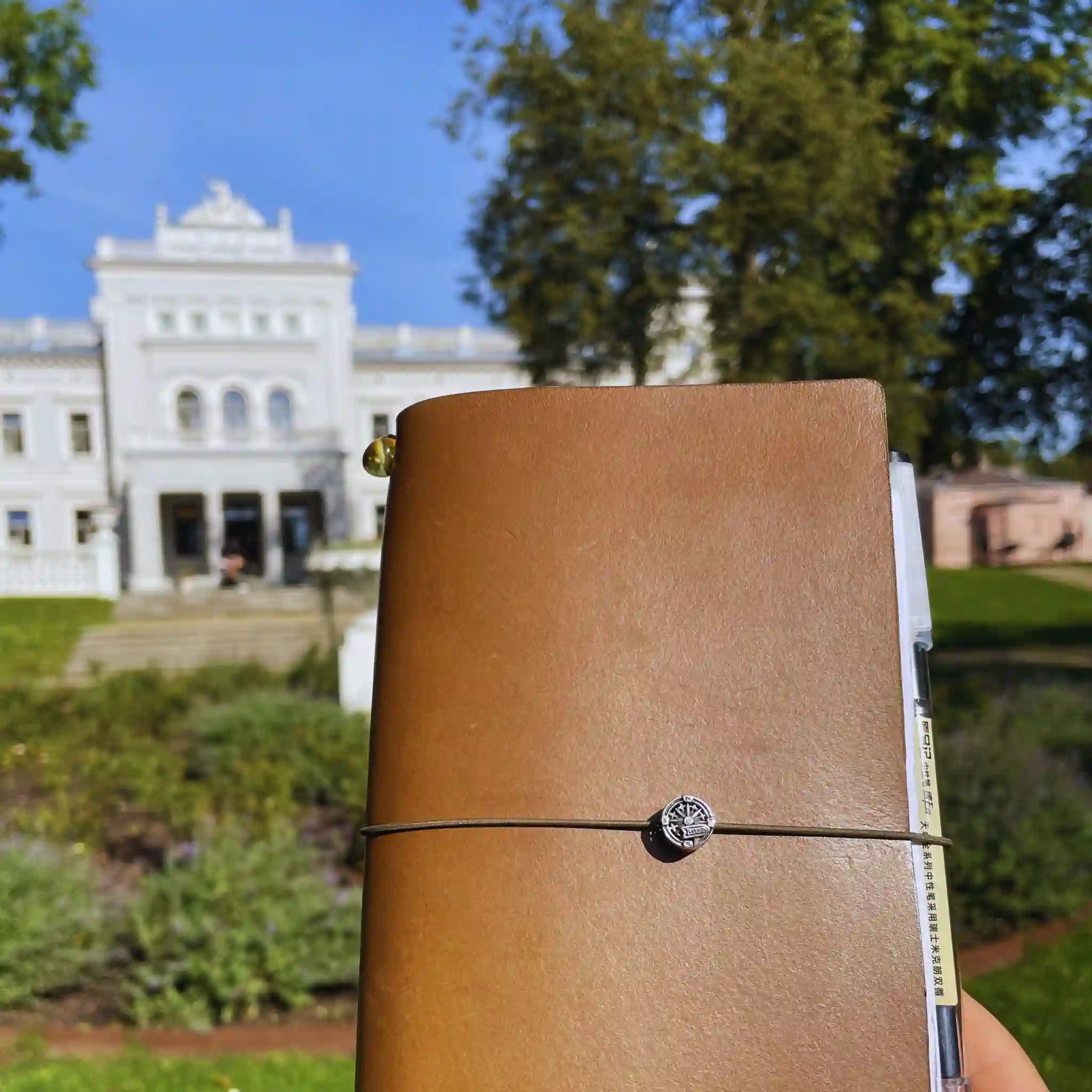 handmade-army-green-leather-travelers-journal-silver-charm.webp