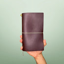 Bielinis handmade traveler’s leather journal Atlas in dark brown, front view featuring genuine Baltic amber detail and premium Italian leather craftsmanship.