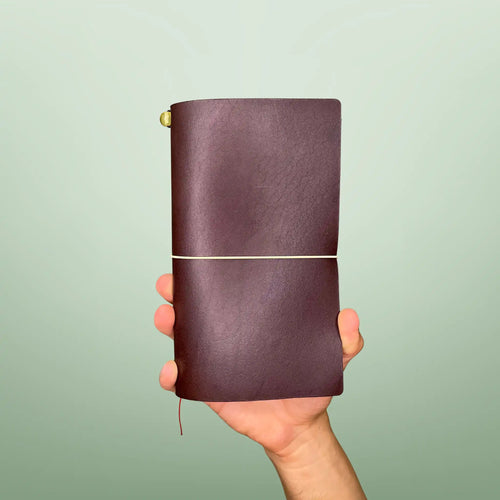 Bielinis handmade traveler’s leather journal Atlas in dark brown, front view featuring genuine Baltic amber detail and premium Italian leather craftsmanship.