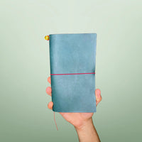 Bielinis handmade traveler’s leather journal Atlas in petrol blue, front view showcasing genuine Baltic amber detail and high-quality Italian leather craftsmanship.