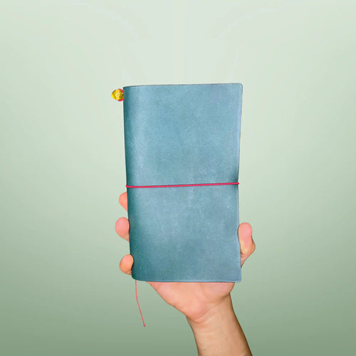 Bielinis handmade traveler’s leather journal Atlas in petrol blue, front view showcasing genuine Baltic amber detail and high-quality Italian leather craftsmanship.