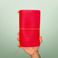 Bielinis handcrafted traveler’s journal Atlas in vibrant red leather, front view highlighting genuine Baltic amber accents and premium Italian leather quality.