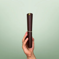 Bielinis handmade traveler’s journal Atlas in rich dark brown leather, side view highlighting genuine Baltic amber accents and fine craftsmanship.