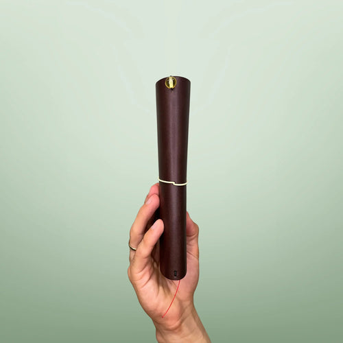 Bielinis handmade traveler’s journal Atlas in rich dark brown leather, side view highlighting genuine Baltic amber accents and fine craftsmanship.