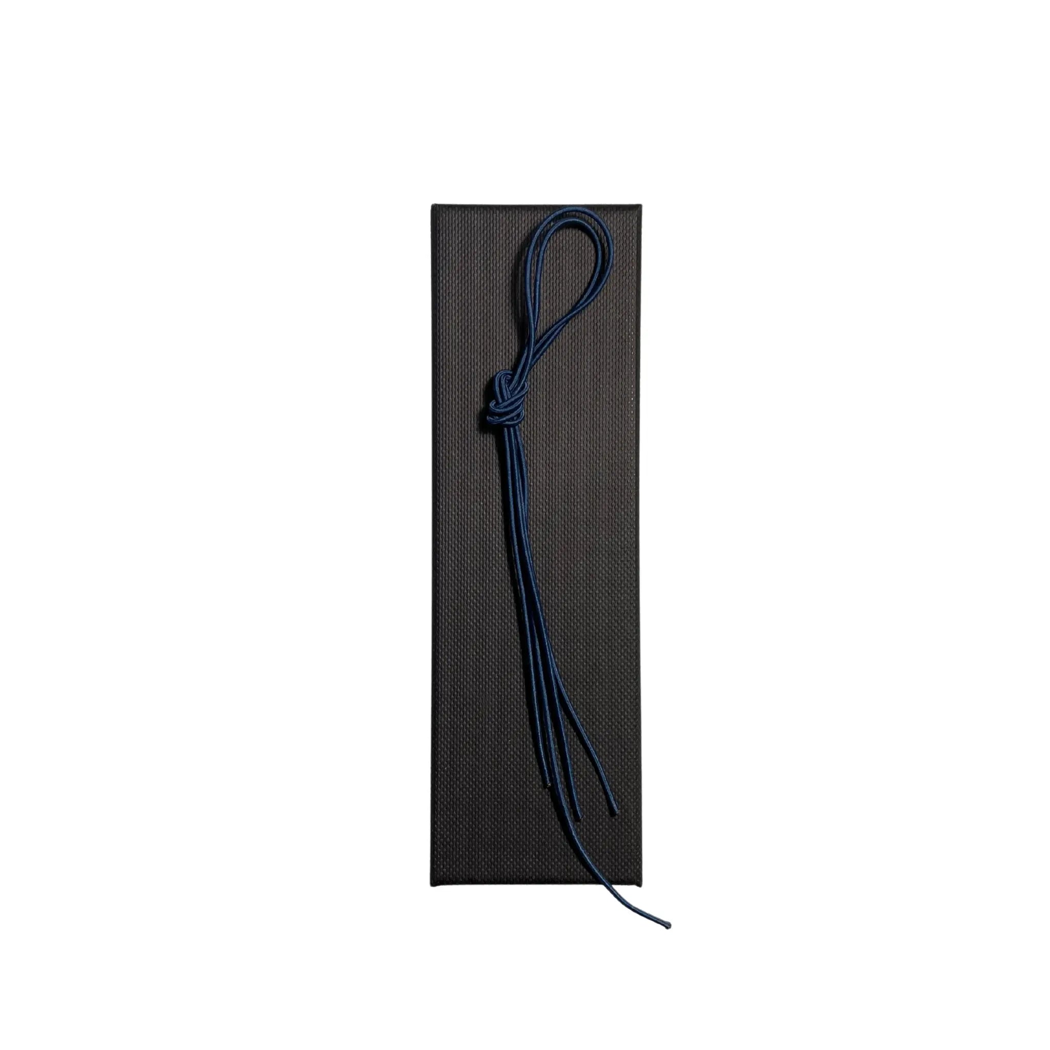 Elastic cord closure for handmade leather traveler’s journal in navy blue, available in various colors.