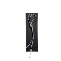 Elastic cord closure for handmade leather traveler’s journal in sky blue, available in various colors.