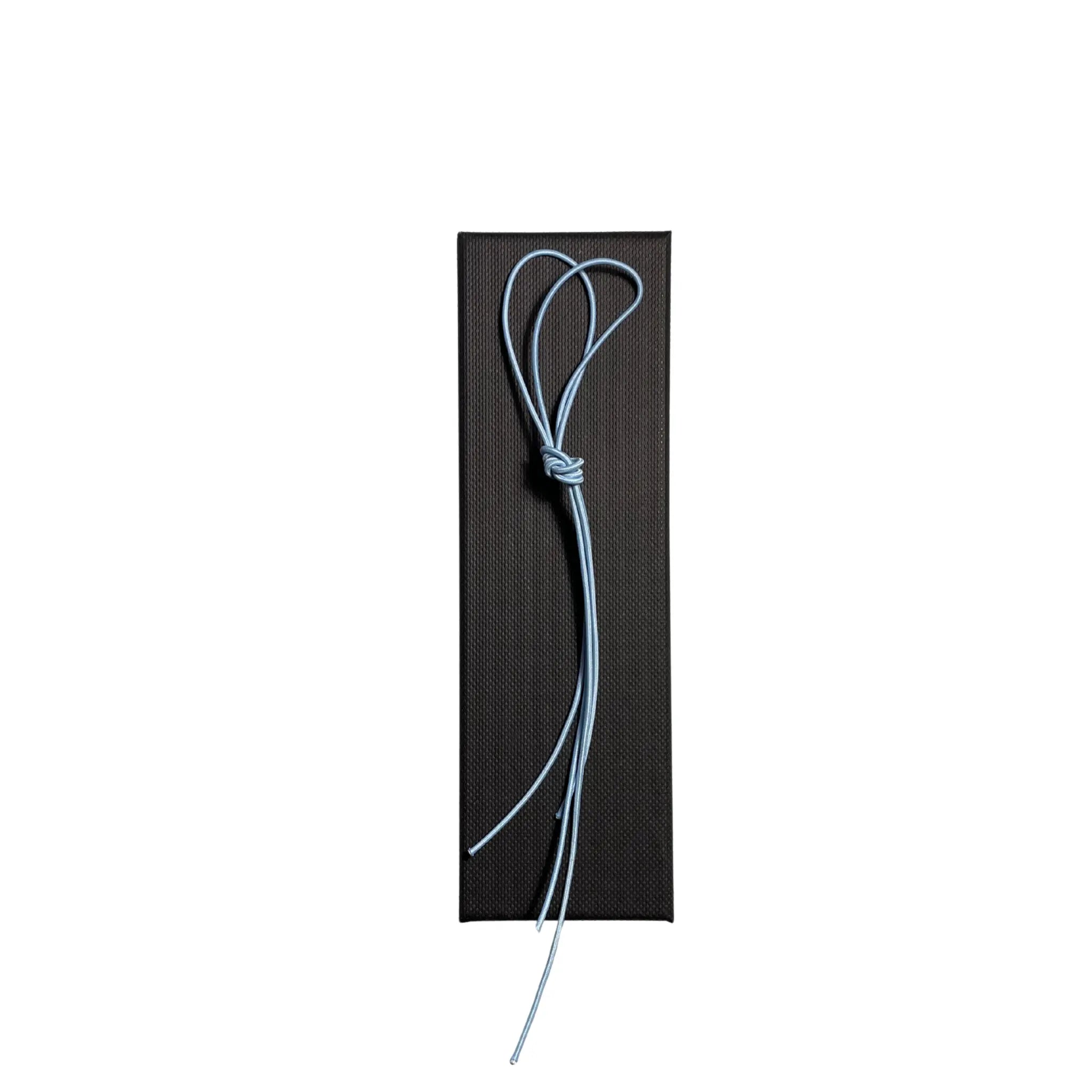 Elastic cord closure for handmade leather traveler’s journal in sky blue, available in various colors.