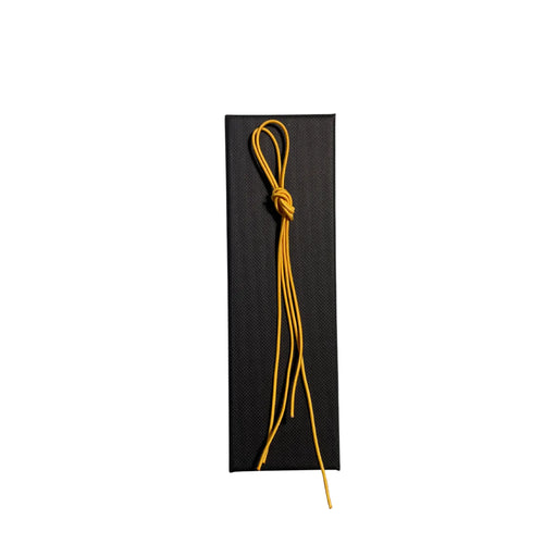 Elastic cord closure for handmade leather traveler’s journal in yellow, available in various colors.